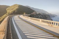 a view of a curvy road by the ocean in california state usa at sunset