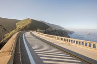 a view of a curvy road by the ocean in california state usa at sunset