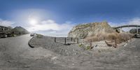 a 360 view shows the scene in action while driving over rocks on a highway with a big rock in the foreground