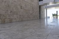 this concrete wall is an architectural feature in the interior of a building with a window at the bottom