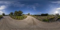 a dirt road runs through the countryside at a hilltoptop as if from a mirror