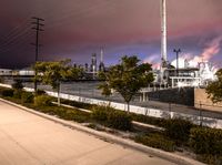 a factory with a lot of smoke going into it on a cloudy night of day