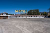 a motel sign on top of an empty building in the desert near palm valley, california