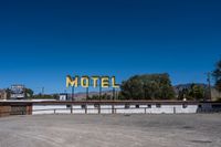 a motel sign on top of an empty building in the desert near palm valley, california