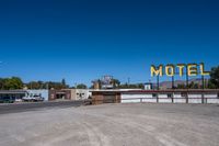 a motel sign on top of an empty building in the desert near palm valley, california