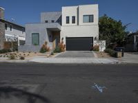 a home sits on the corner of a street with blue bins and gravel driveway