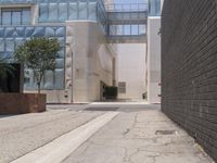 a street corner with a paved sidewalk and some tall buildings in the background of this photo