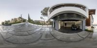 an artisticly designed home on a hill in the desert, as seen from a fish eye view