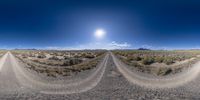 an image of a dirt road taken in a 360 lens on a sunny day in the desert