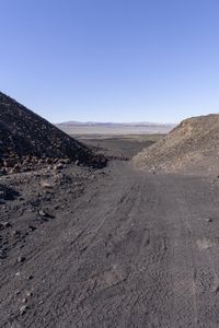 a dirt road that is very narrow with no vehicles on it in the desert,