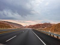 an empty highway and a car with no passengers is shown in this photograph from the backseat