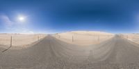 panorama fish eye shot looking up at the sky over the sand hills and desert area