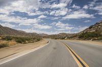 the view of a deserted highway and mountains on the horizon is as though in motion