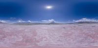 the desert under a partly cloudy sky is completely deserted with a little bit of sun