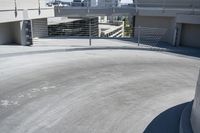 a man in a hat is on his skateboard in a parking lot near some buildings