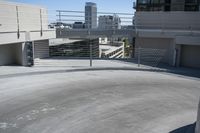 a man in a hat is on his skateboard in a parking lot near some buildings