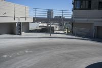 a man in a hat is on his skateboard in a parking lot near some buildings