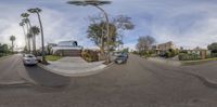 a view of a street from the top of a house looking like this fish eye lens is very amazing