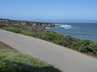 California Highway: Asphalt, Grass, and Coastal Views