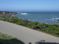 California Highway: Asphalt, Grass, and Coastal Views