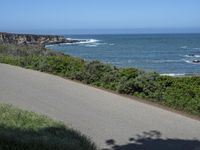 California Highway: Asphalt, Grass, and Coastal Views