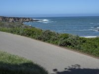 California Highway: Asphalt, Grass, and Coastal Views