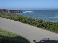 California Highway: Asphalt, Grass, and Coastal Views