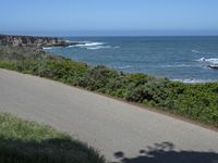 California Highway: Asphalt, Grass, and Coastal Views