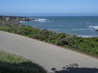 California Highway: Asphalt, Grass, and Coastal Views