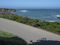 California Highway: Asphalt, Grass, and Coastal Views