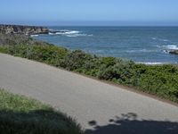 California Highway: Asphalt, Grass, and Coastal Views