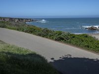 California Highway: Asphalt, Grass, and Coastal Views