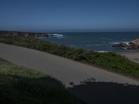 California Highway: Asphalt, Grass, and Coastal Views