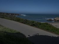 California Highway: Asphalt, Grass, and Coastal Views