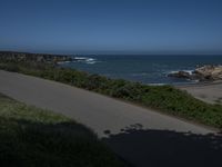 California Highway: Asphalt, Grass, and Coastal Views