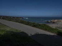 California Highway: Asphalt, Grass, and Coastal Views