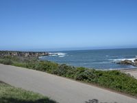 California Highway: Asphalt, Grass, and Coastal Views