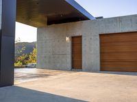 garage door and garage floor with trees in the distance next to it, and mountain views