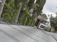 the exterior and landscape of a modern house in los angeles, california with stone and wood