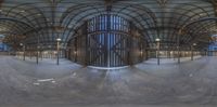 this is an indoor skate park with a big wooden ramp and circular lighting inside it