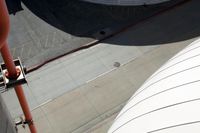 an aerial view of the street and sidewalk, from above, of an airplane in the sky