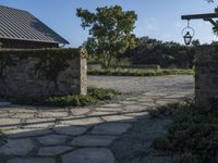 a home with stone stepping around the front yard and the large door leading to the front yard