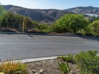 this is a view of the street that goes down to the mountains at dusk from across the street