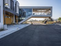 a modern building has large stairs on it in the middle of a city street, near some trees