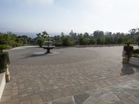 some black statues standing on a paved patio with trees in the background and a view out