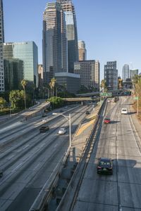 the freeway is moving along the city streets and has lots of buildings around it as it approaches