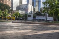 a public plaza is in the city square, in between skyscrapers and other buildings