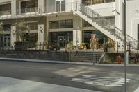 this is an image of a building on a street corner with stairs and a stoplight