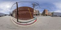 an image of a fisheye view from across a street with the power lines overhead