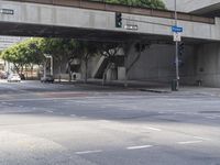 there is a street under a bridge that leads to the other side of the street